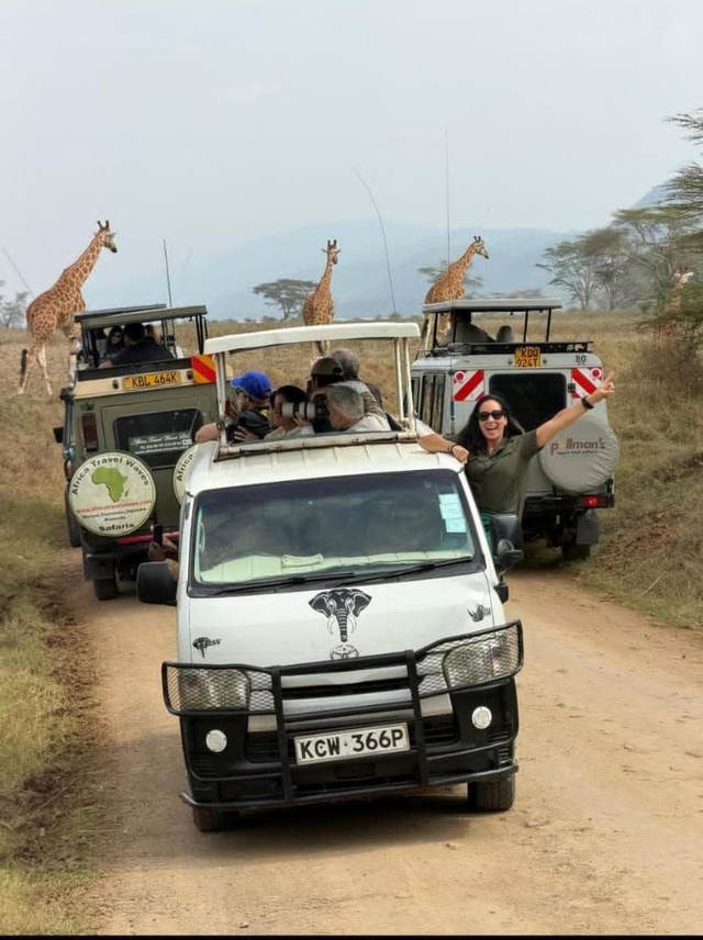 Group of ELMAG SAFARIS safari vans together on a game drive in Kenya