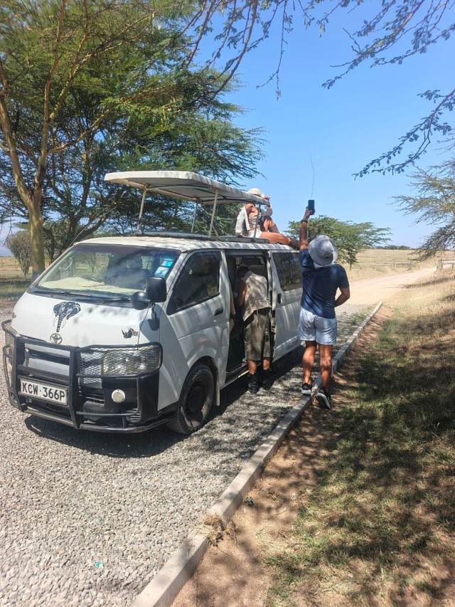 ELMAG SAFARIS pop-top safari van parked on open savanna in Kenya